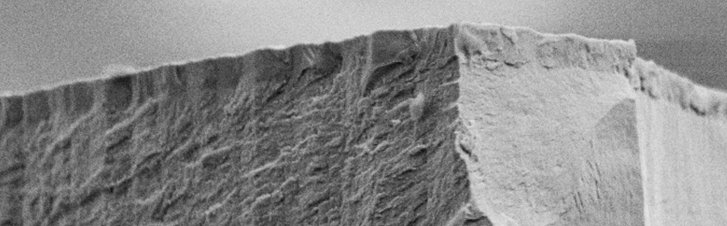 Typical layered structure (SEM micrograph) with adhesion-promoting layer (bottom), magnetic functional layer (middle), and wear and corrosion protection layer (top).