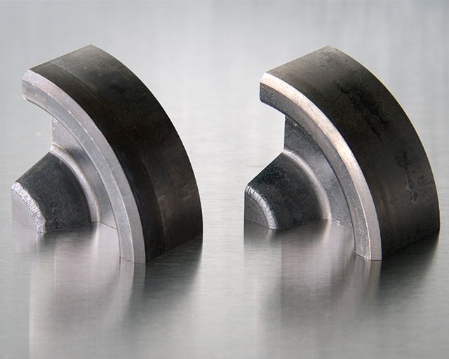 Experimental tool for hot forging applications: Nitrided reference tool showing wear pattern on the mandrels of the test tool after 3000 forming operations at 1150 °C (left), test tool with optimized boron-containing multilayer coating system Ti-B-N with significantly reduced wear pattern on  the mandrels of the test tool after 3000 forming operations at  1150 °C (right).