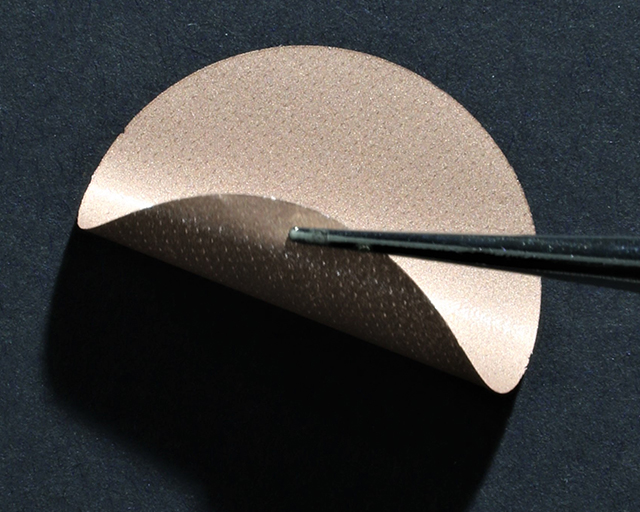 Sample of a copper-coated polymer foil as a weight-reduced power collector for use in lithium-ion batteries. Compared to common copper anode foils, the weight per unit area is reduced by approx. 25 percent. 