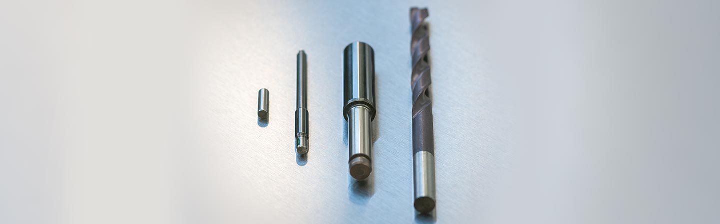 Examples of cylindrical SIMS specimens with three DLC films and a CrAlN film (drill bit).